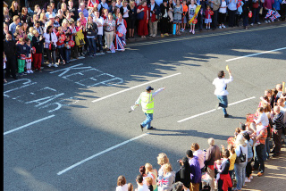Illustration for article titled Barricade-Jumping Video Game Developer Runs The Olympic Torch Route With A Banana